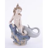 Lladro, a porcelain figure of a Mermaid on a rocky base, height 30cm.