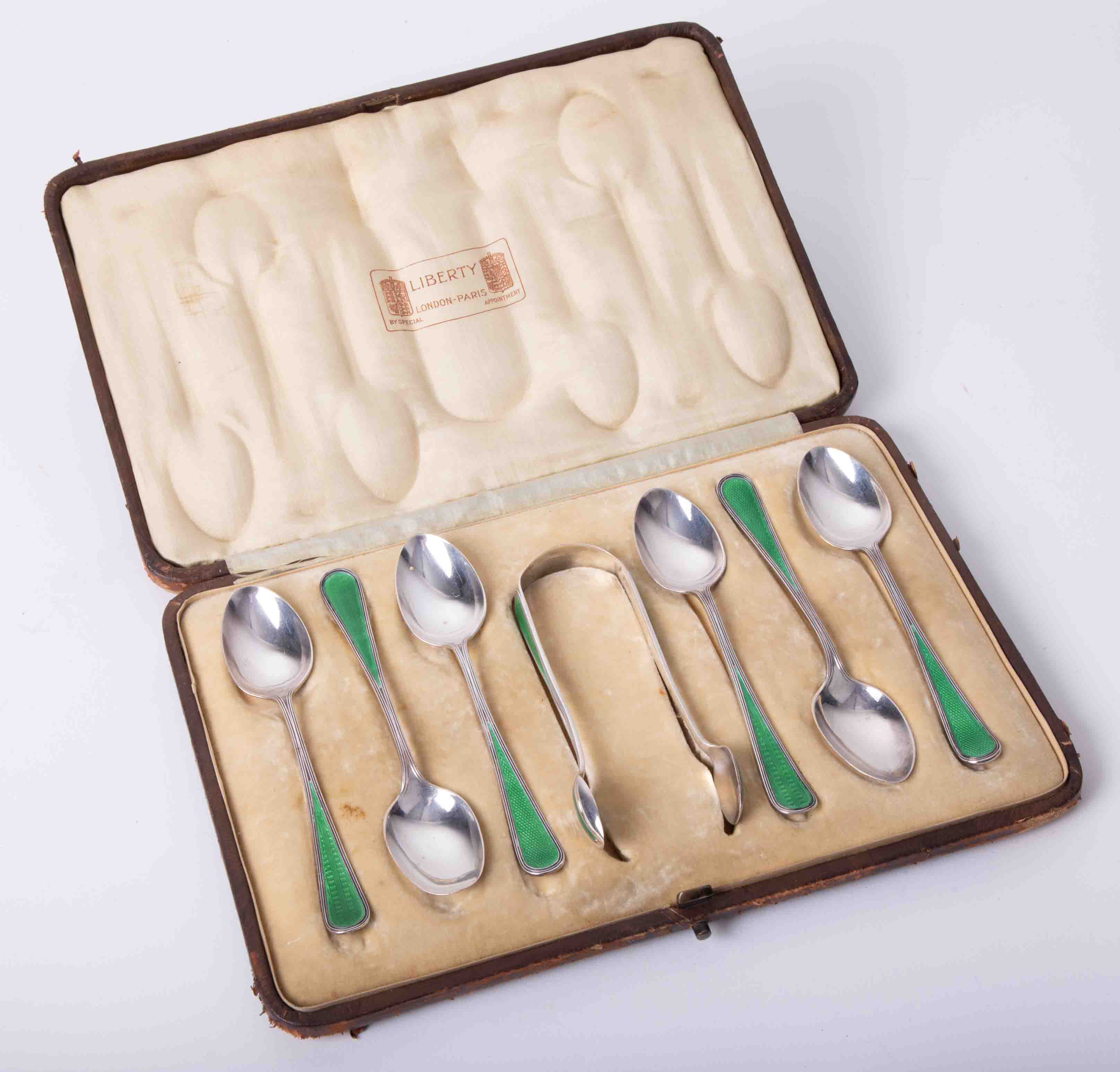 A boxed set of Liberty & Co enamel tea spoons and tongs, 7 piece.