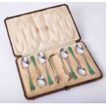 A boxed set of Liberty & Co enamel tea spoons and tongs, 7 piece.