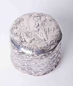 An embossed silver pot with cover, decorated with a figure on horseback, height 4cm.