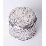 An embossed silver pot with cover, decorated with a figure on horseback, height 4cm.