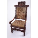 A 19th Century carved walnut high back arm chair with tapestry covers, height 132cm, Provenance;