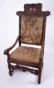 A 19th Century carved walnut high back arm chair with tapestry covers, height 132cm, Provenance;