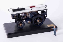 A Bassett Lowke precision scale white metal model of a traction engine, on stand, length 15cm, 68/