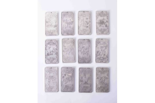 A Chinese Animal Year Maio calendar set (12 in white metal each approx. 10cm x 5cm).