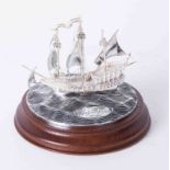 Royal Mint silver model of The Golden Hind upon circular choppy sea, 12cm diameter on wood base,