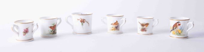 Six Royal Worcester miniature mugs decorated with birds.