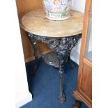 A heavy cast iron pub table possibly 19th Century with lion paw feet, with crests of Britannia?