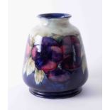 A William Moorcroft vase decorated with purple anemones, height 16cm, fully restored and rebuilt.