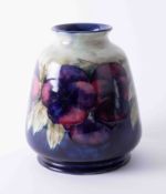 A William Moorcroft vase decorated with purple anemones, height 16cm, fully restored and rebuilt.