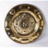 An antique circular brass alms dish.