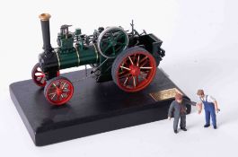 A Bassett Lowke precision scale white metal model of a traction engine, on stand, length 13cm.