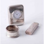 Cartier, Paris lighter 101062, silver napkin ring and travel clock (3).