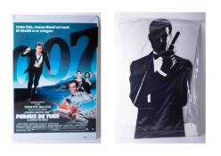 A James Bond full height cut out cardboard figure together with a Timothy Dalton tin sign (Licence