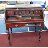A Victorian mahogany cylinder writing desk together with a mirror.