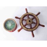 A Sestrel Marine compass, 18cm diameter, together with a small scale ships wheel with brass