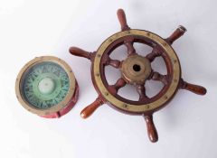 A Sestrel Marine compass, 18cm diameter, together with a small scale ships wheel with brass