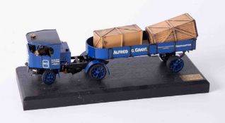 A Bassett Lowke precision scale white metal model of a flatbed lorry, on stand, length 22cm.