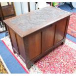 A small lined blanket chest with carved top.