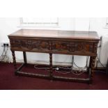 An early 20th century oak low dresser fitted with drawers with geometric mouldings and turned legs.