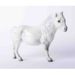 A Beswick dapple grey pony, height 14cm.