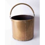 A large brass 'studded' coal bucket with swing handle, diameter 30cm.