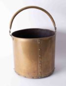 A large brass 'studded' coal bucket with swing handle, diameter 30cm.