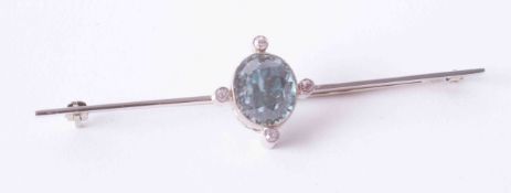 An Art Deco white gold bar brooch set approx. 2.50 carat oval blue zircon and four small diamonds,