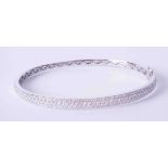 A fine 18ct white gold pave set diamond bangle, approximately 19.3g.