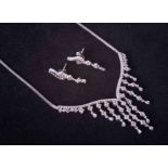 An 18ct white gold graduated style necklace set diamonds together with a pair of matching drop