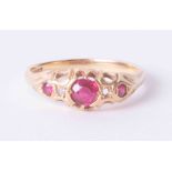 An antique 18ct yellow gold ring set three rubies and diamonds (one diamond missing), 3.3g, finger