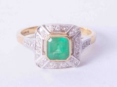 An 18ct yellow gold cluster ring of Art Deco style set approx. 0.75 carat emerald, surrounded by