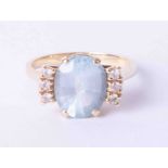 An unusual design 14ct yellow gold ring set oval aquamarine, approx. 3.75 carats with diamonds to