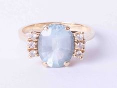 An unusual design 14ct yellow gold ring set oval aquamarine, approx. 3.75 carats with diamonds to