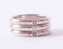 A set of three Tiffany & Co silver stacking rings by Peretti set with peridot, pink sapphire &