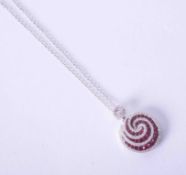 An 18ct white gold ruby & diamond swirl pendant on a fine chain.