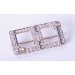 An Art Deco diamond and sapphire brooch with a mixture of round and baguette cut stones, 35mm x