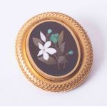 An ornate yellow gold 'Pietra Dura' oval brooch with a mosaic hardstone flower design centre, 13g.