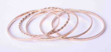 A set of five 9ct yellow gold handmade bangles including plain and a twist design bangle (4), 46.