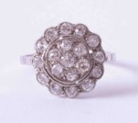 A fine platinum antique diamond flower cluster ring, circa 1910, finger size N.