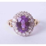 An 18ct yellow gold cluster ring set oval cut amethyst, approx. 2.50 carats, surrounded by old cut