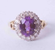 An 18ct yellow gold cluster ring set oval cut amethyst, approx. 2.50 carats, surrounded by old cut