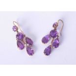 A pair of antique gold and amethyst & seed pearl set filigree style drop earrings.