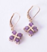 A pair of 9ct yellow gold drop earrings set round cut amethysts in cross style design, 3.5g.