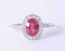 A platinum cluster ring set oval ruby approx. 0.65 carat, surrounded by diamonds in a milgrain