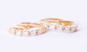 A pair of 9ct yellow gold hoop earrings set approx. 0.60 carat (total weight) of diamonds, 4g.