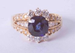 An 18ct yellow gold ornate diamond and cushion cut tanzanite ring (approx. 2.50 carat), finger