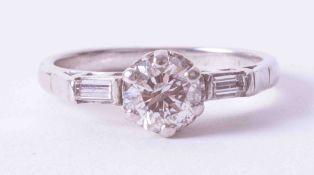 An 18ct white gold Art Deco ring set approx. 0.75 carat round brilliant cut diamond and baguette cut