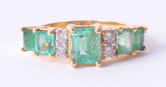 A yellow gold 9 stone ring set emeralds & diamonds in a mixture of cuts, finger size N.