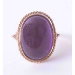 A large 9ct yellow gold ring set an oval cabochon amethyst, 6.6g, finger size O.